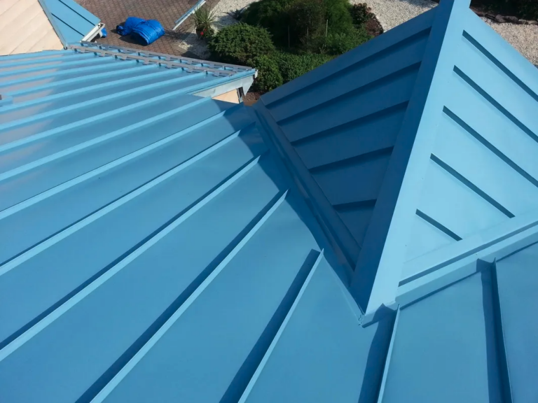 A blue metal roof with a ridge and corner.